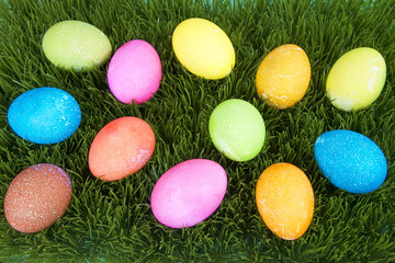 Fototapeta na wymiar Colorful hand painted decorated easter eggs with speckled texture