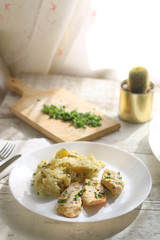 Grilled chicken fillets marinated in lemon juice and olive oil, with mashed potatoes cooked with sour cream and parsley. More parsley on the side.  Selective focus. 