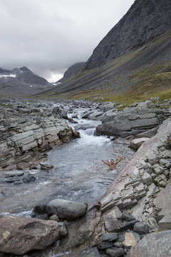 Man in stream in mountains