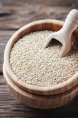 Raw healthy quinoa on the wooden table
