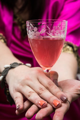 Having glass of wine in girle's hands.