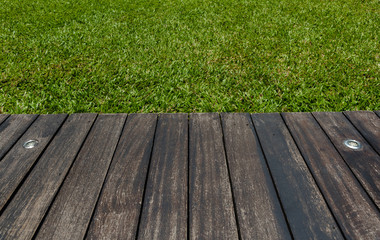 wooden terrace with  lighting and grass background