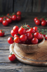 Fototapeta na wymiar Red tomatoes cherry on the wooden table