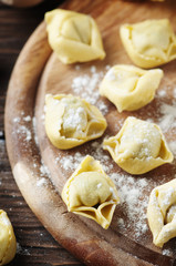 homemade Italian traditional tortellini on the wooden table