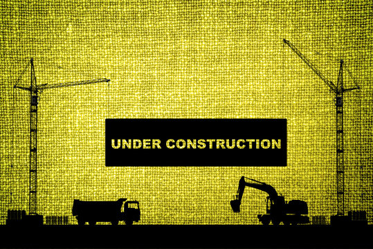 "Under construction" concept at building site with detailed silhouettes of construction machines on olive color cloth texture background