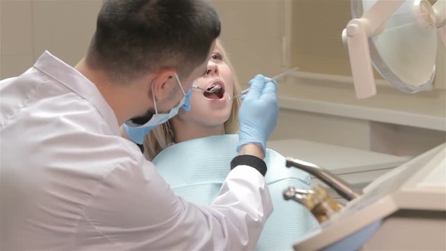 Dentist checks up girl's teeth