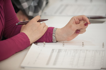 Businessman working with documents. Close-up of hands with pen over paper during conference
