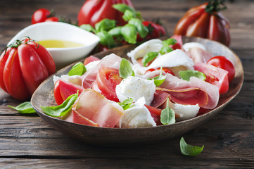 Italian salad caprese with ham and mozzarella