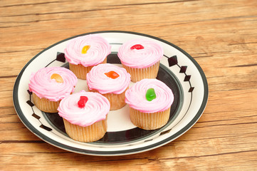 Pink cupcakes displayed on a plate