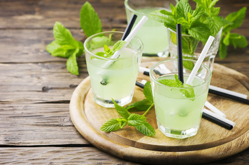 Green sweet alcohol cocktail with mint and ice