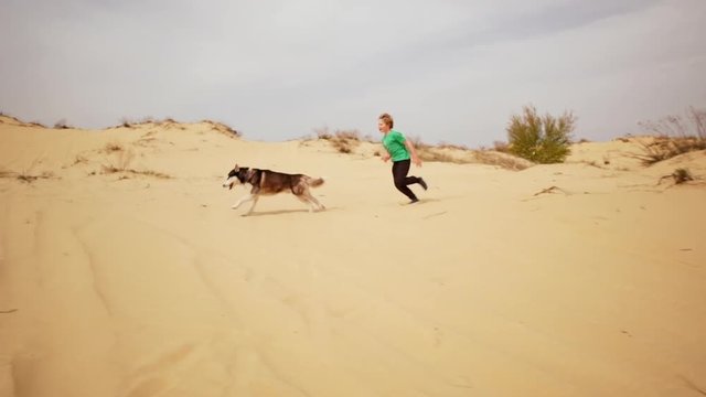 Kids playing and doing sport on sand. Slow motion