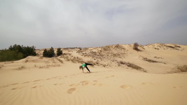 Family spending time together and having fun in Oleshky sands.Ukraine. Slow motion