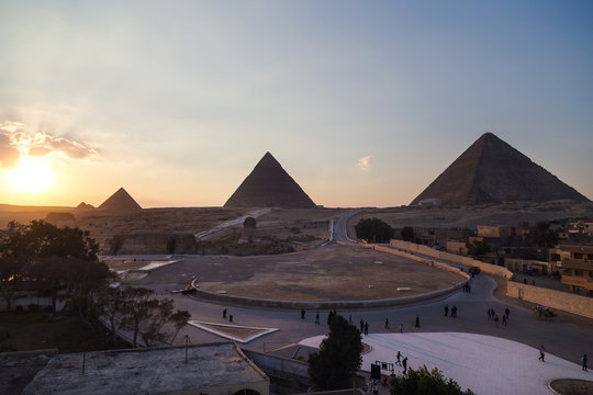 Tourist groups heading to the Sphinx and Great pyramid of Giza, Egypt.