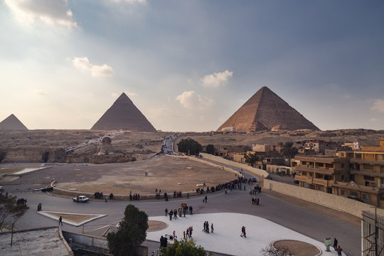 Tourist groups heading to the Sphinx and Great pyramid of Giza, Egypt.