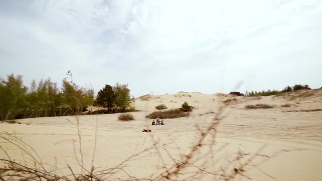 Family spending time together and having fun in Oleshky sands.Ukraine. Slow motion
