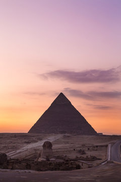 The Sphinx at sunset with great pyramid of Giza in background.