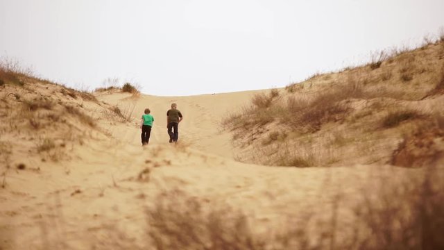 Family spending time together and having fun in Oleshky sands.Ukraine. Slow motion