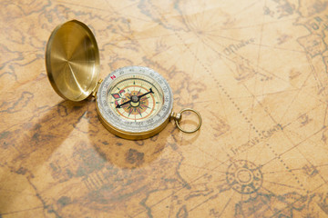 Fototapeta na wymiar old compass on vintage map