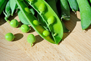pod green peas on wood background