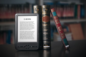 Fototapeta premium E-book reader device on desk in library