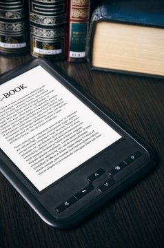 E-book reader device on desk in library