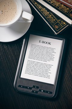 E-book reader device on desk in library