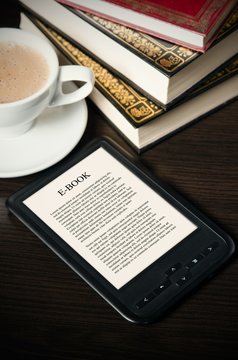 E-book reader device on desk in library