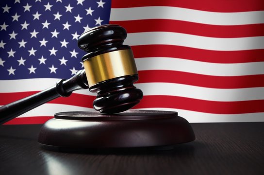 Wooden gavel with USA flag in background