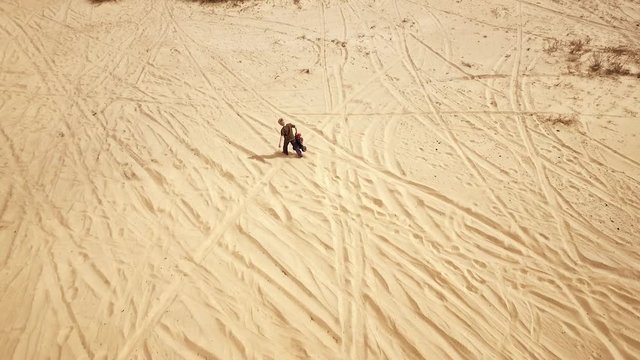 Family spending time together and having fun in Oleshky sands.Ukraine. Slow motion