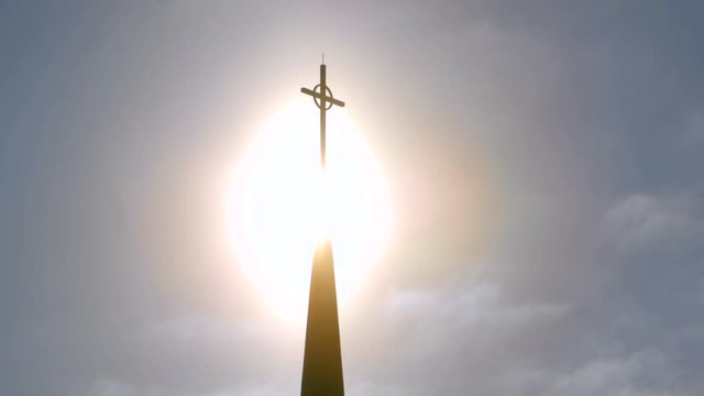 Dramatic sunlight behind church cross