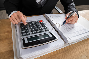 Male Accountant Calculating Tax