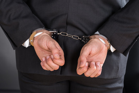 Close-up Of Businessman In Handcuffs