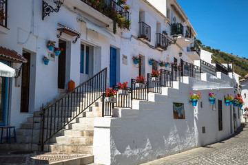 Obraz premium Picturesque street of Mijas with flower pots in facades. Andalus