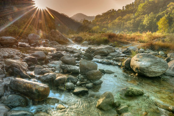 Nice river water flowing through rocks at dawn