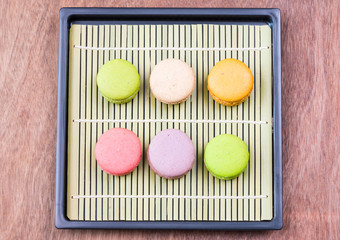 Macarons on a bamboo mat top view 