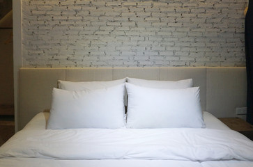 White pillow and bedsheet with focus lighting in the middle