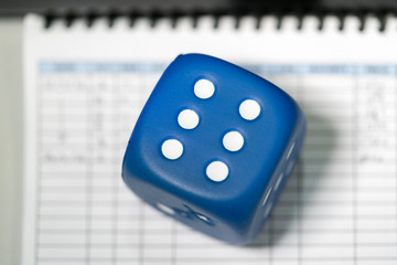 Blue dice on a trading blotter
