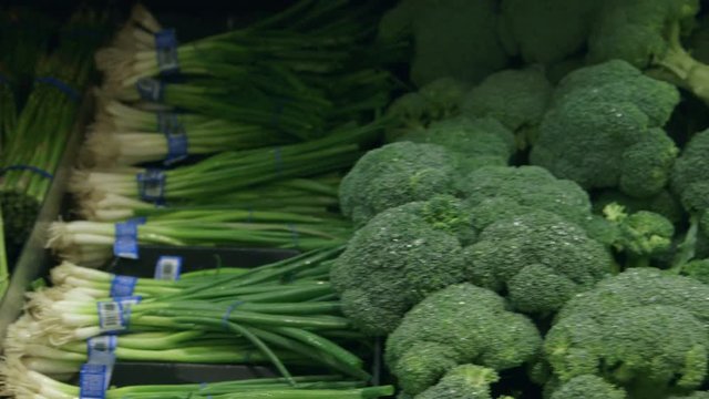 Close-up tracking shot of vegetables in a supermarket