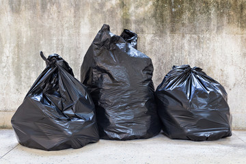 close-up of a full garbage bags on floor