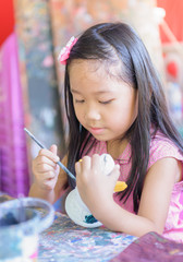 cute girl enjoy to play paint color