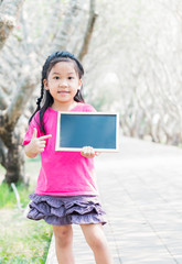 Cute little girl holding a chalkboard