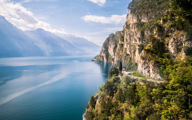 Panorama of the gorgeous Lake Garda surrounded by mountains. - obrazy, fototapety, plakaty