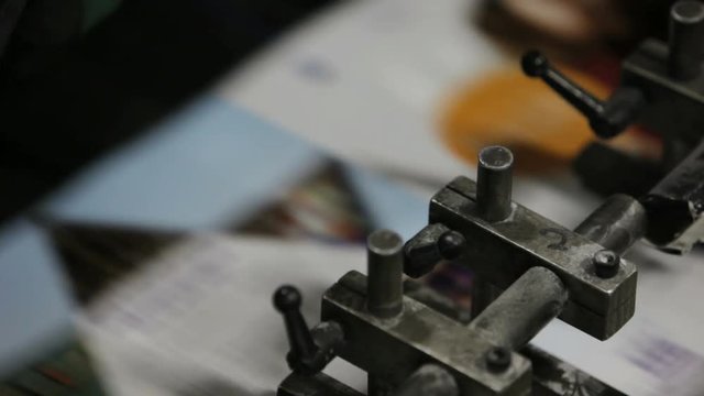 A professional printing press in action, churning out a magazine.