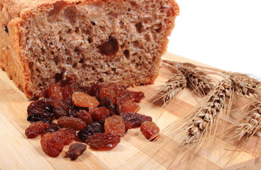 Baked wholemeal bread, raisins and ears of wheat