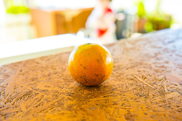 A orange on the wooden table
