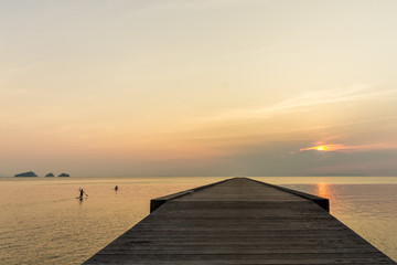 Naklejka na ściany i meble Sunset over pier and sea on a tropical island Koh Samui, Thailand