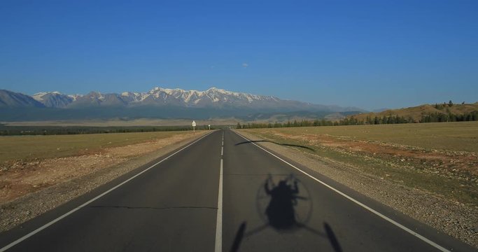 Flying along the road. shadow paramotor