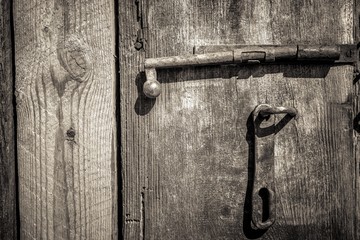 old wooden door with an iron bolt