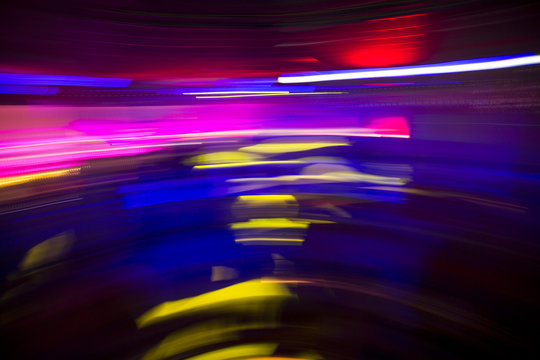 Colorful night club party lights in motion blur, abstract background design on drugs