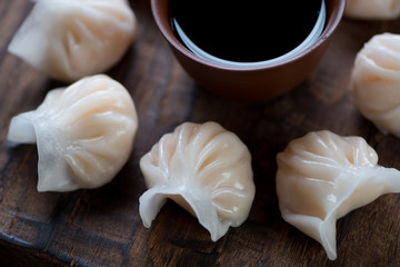 Fototapeta na wymiar Close-up of steamed dim-sum dumplings and soy sauce, studio shot